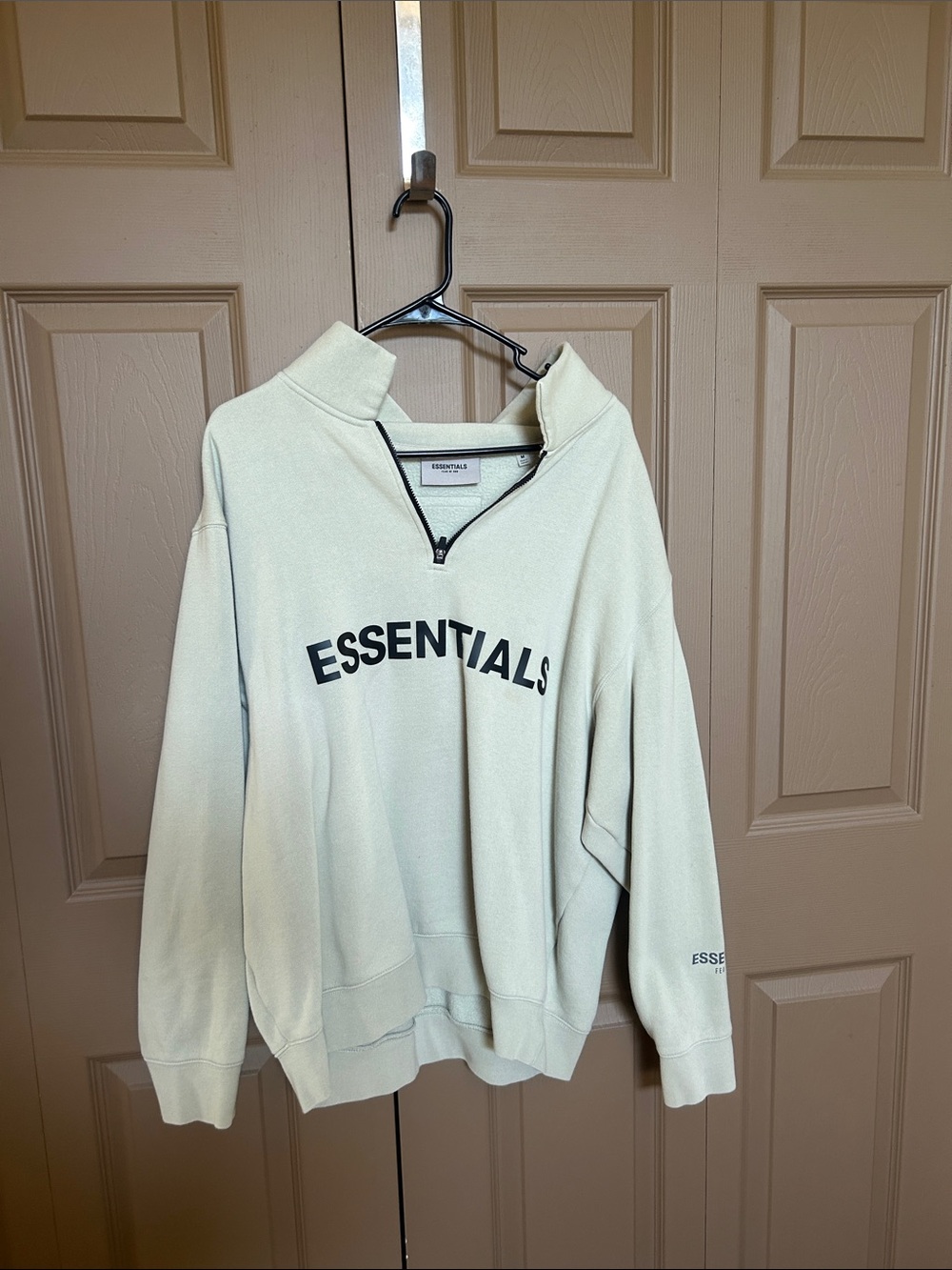 ESSENTIALS Men's Cream Half-Zip Pullover with Bold Logo